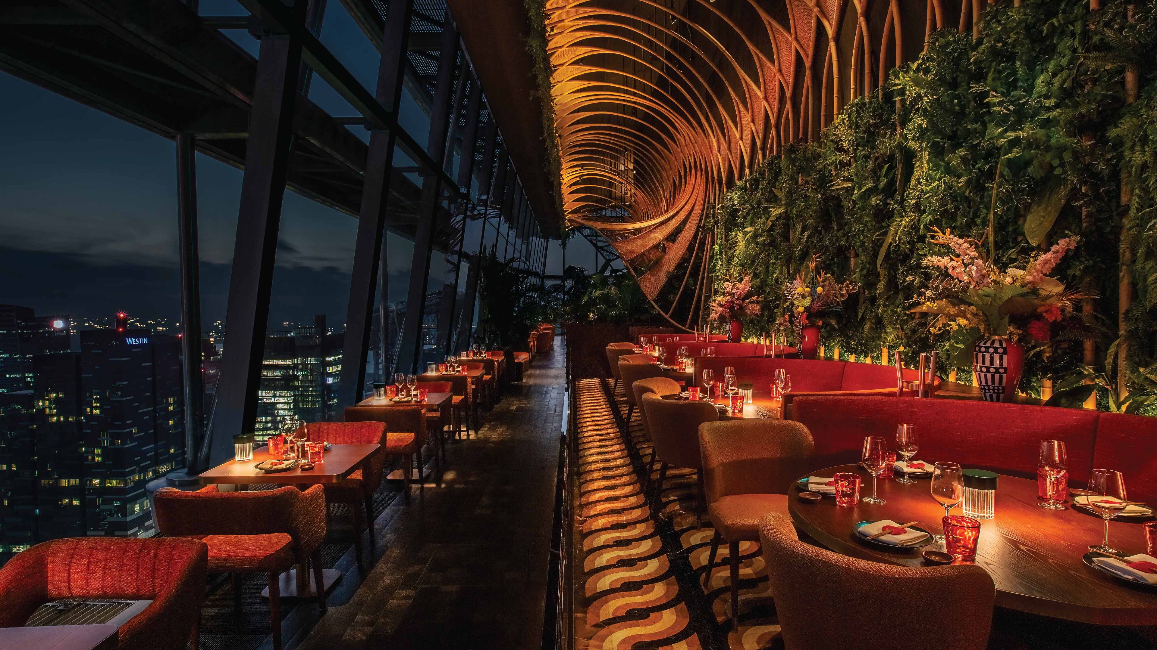 SUSHISAMBA SINGAPORE dining room at night with a view of the city