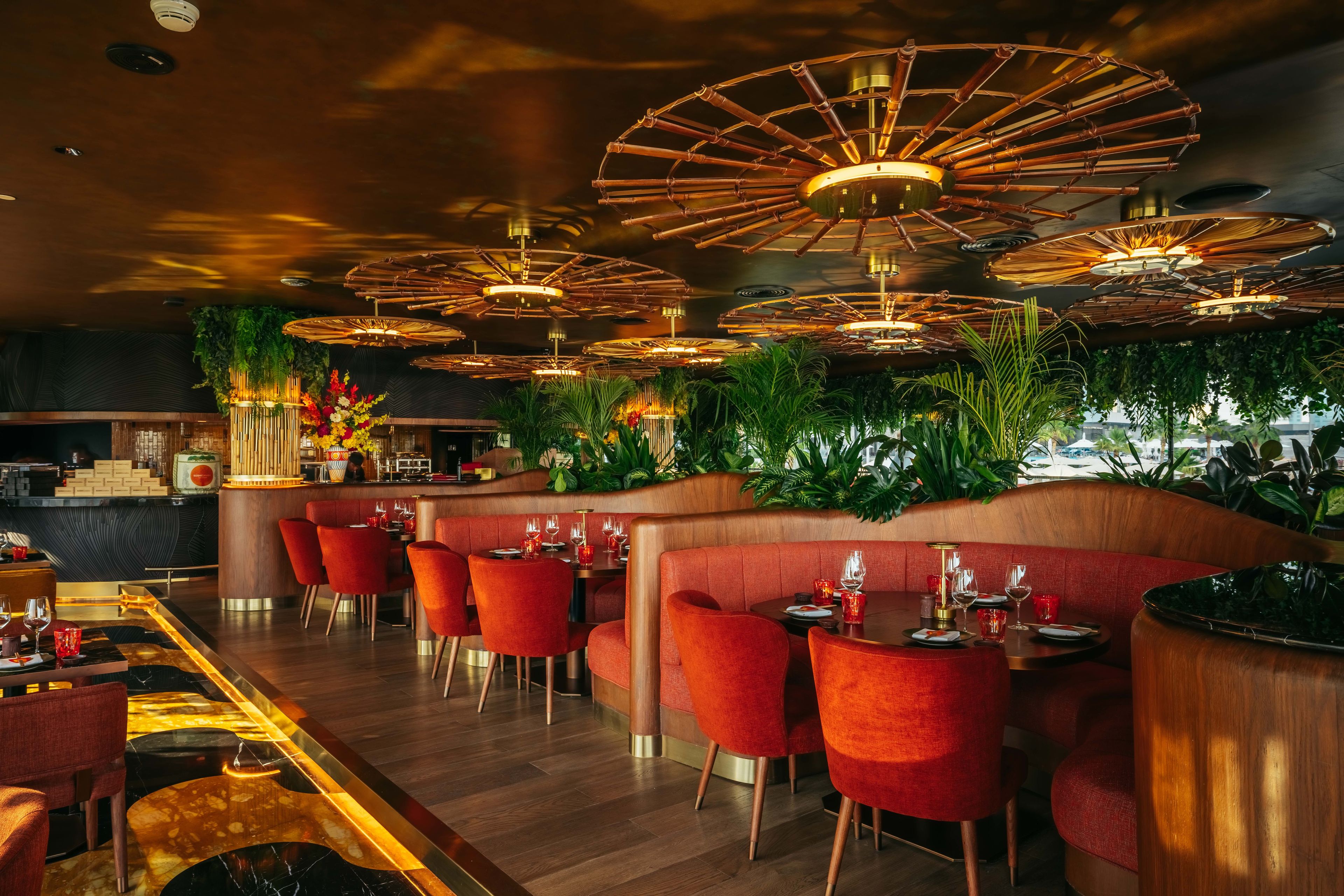 SUSHISAMBA ABU DHABI Restaurant dining room in the daytime with red booths.