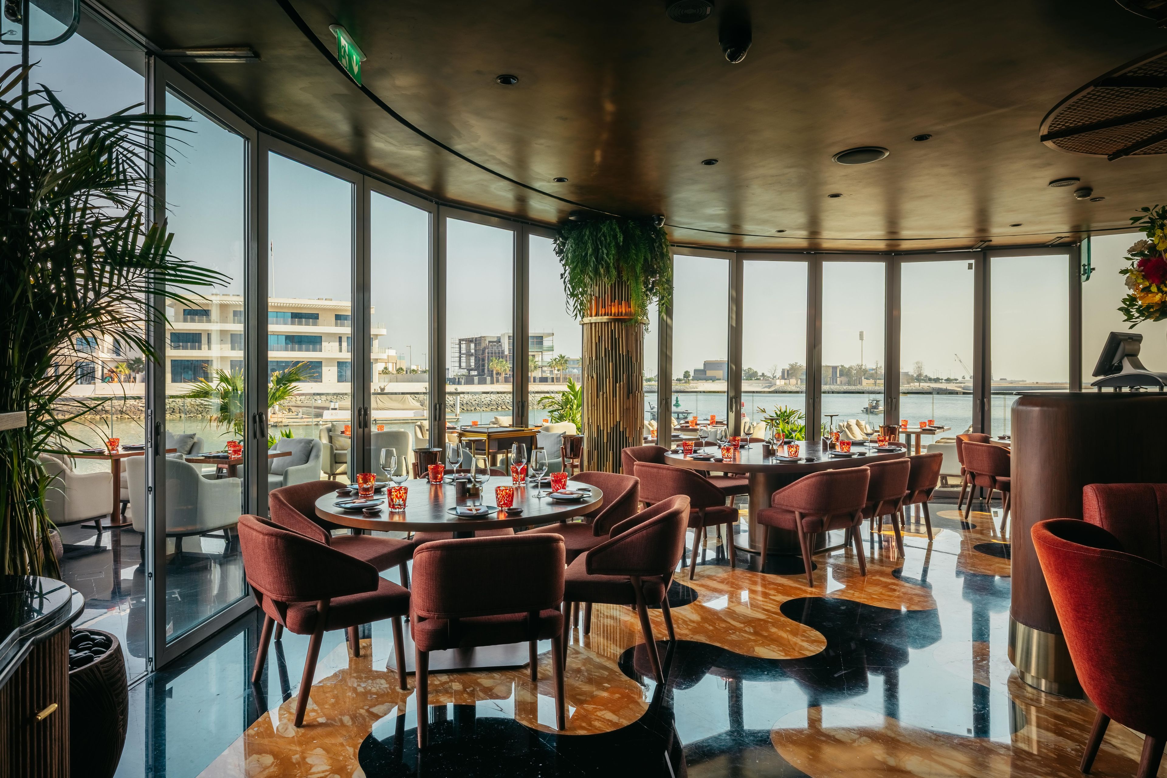 SUSHISAMBA ABU DHABI dining room interior, with a sky to ceiling windows overlooking the view