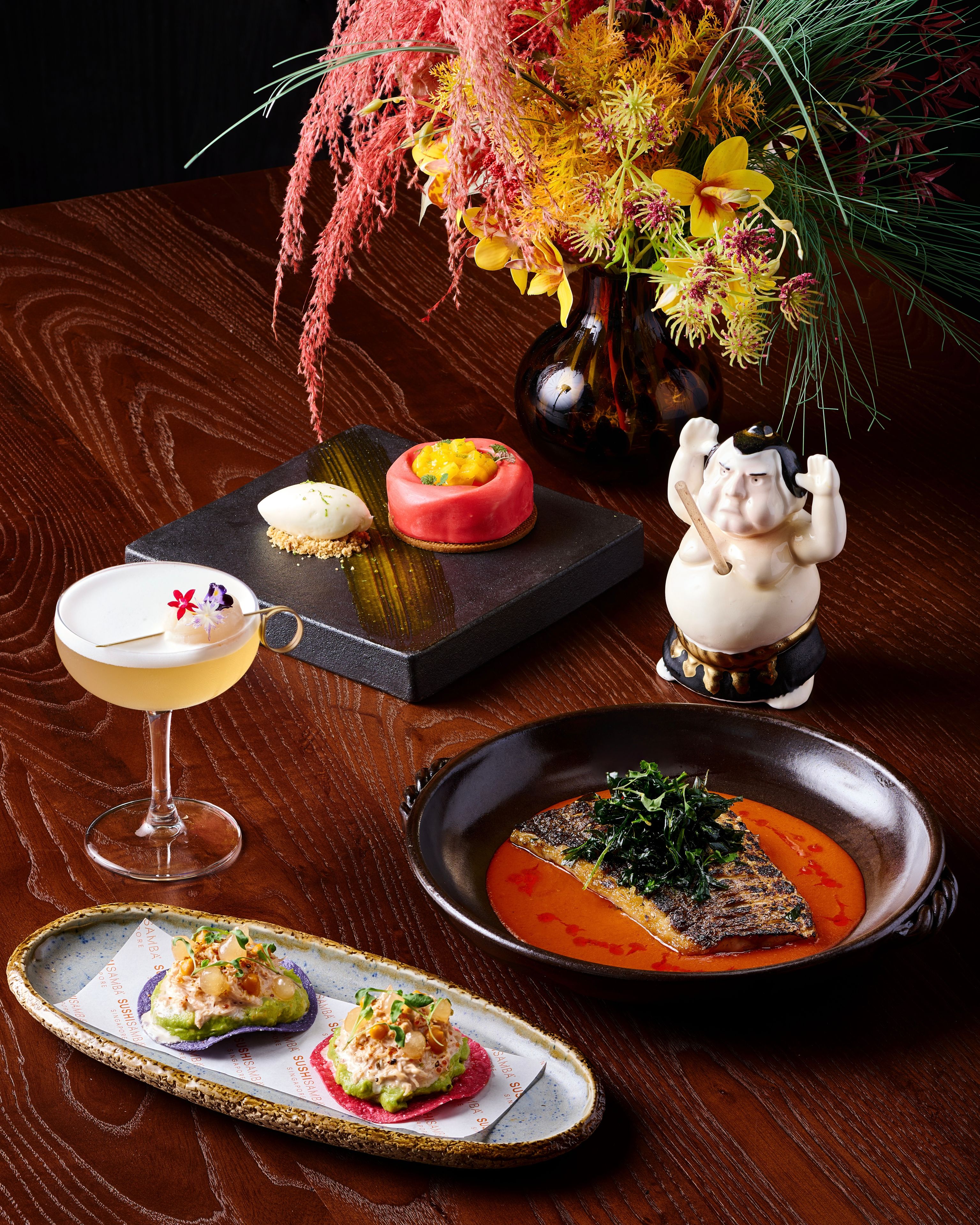 Clockwise right to left, Samba Mama cocktail, Grilled Sea Bass, Crab Tostada, Sakura Rosa cocktail and Pink Peach dessert