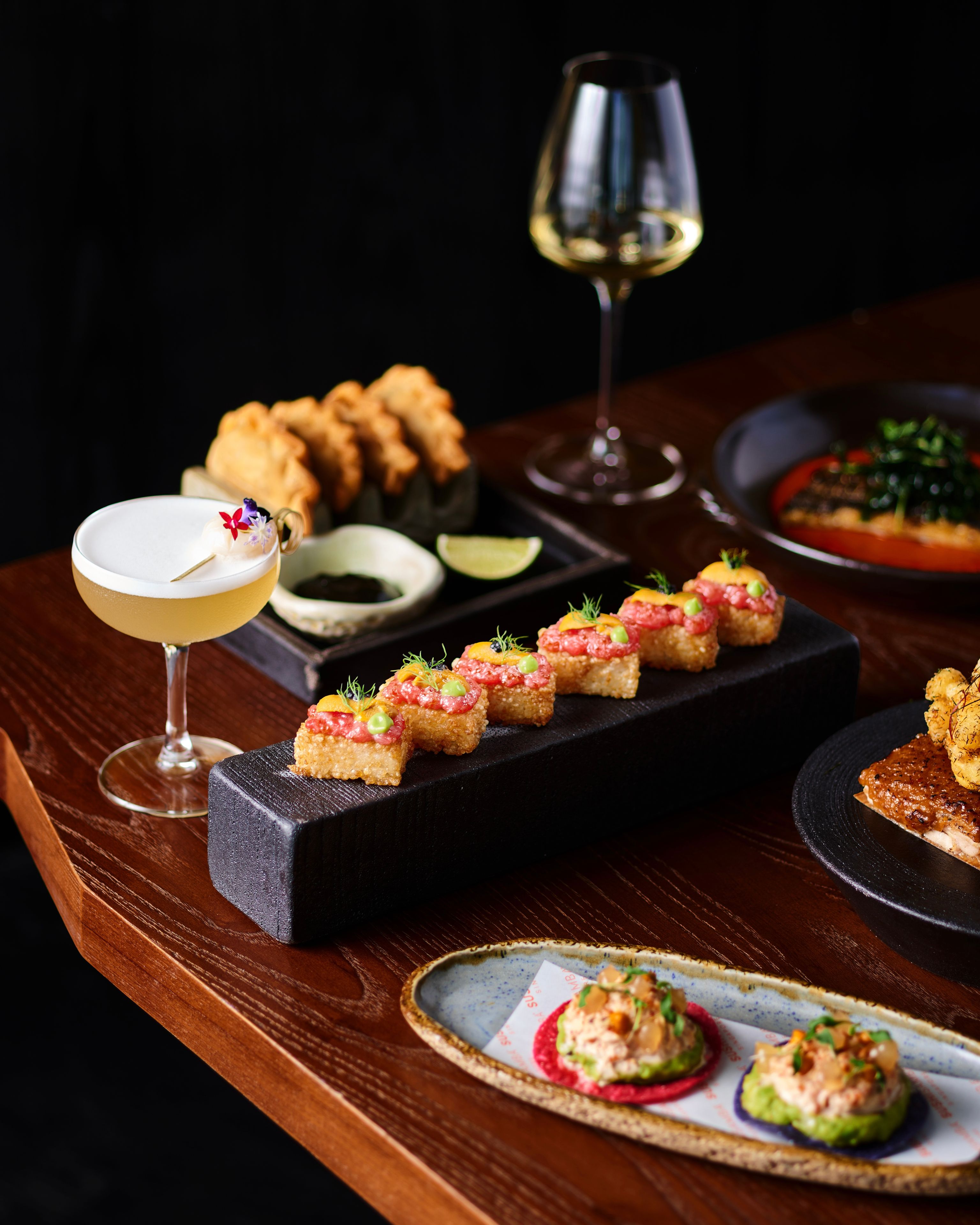 Table of SUSHISAMBA food with drinks, cocktails, sushi and more